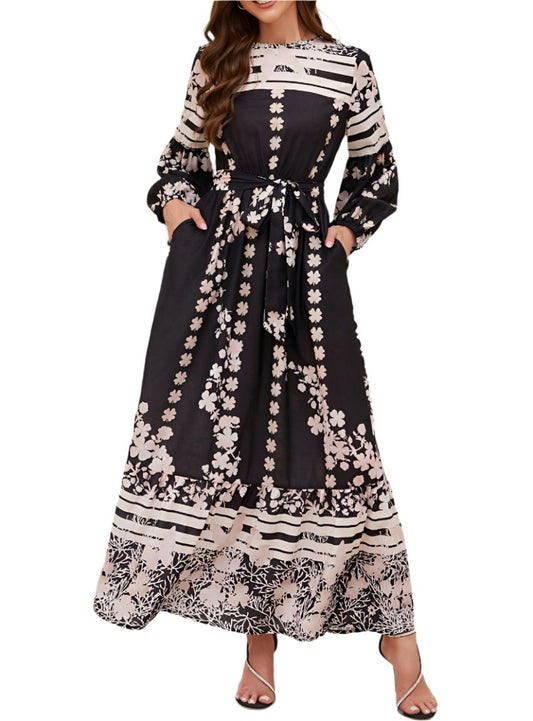 Front view of printed long sleeve maxi dress with waist tie and pockets.
