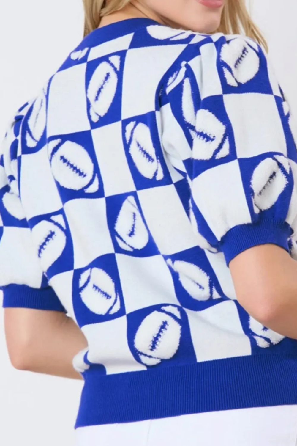 Trendy puff sleeve football sweater in royal blue and white checkerboard print.