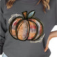 Woman wearing a dark gray pumpkin graphic sweatshirt
