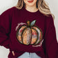 Maroon pumpkin graphic sweatshirt with a playful fall design
