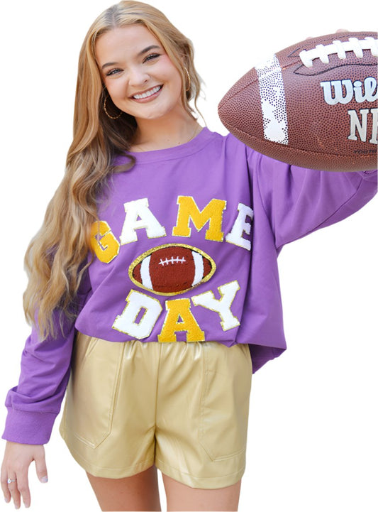 Women's purple "Game Day" sweatshirt with varsity-style lettering and a football graphic.