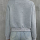 Back view of gray quilted bomber jacket, perfect for layering in cooler weather.