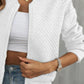 Close up of white quilted bomber jacket, highlighting the ribbed cuffs and hem.
