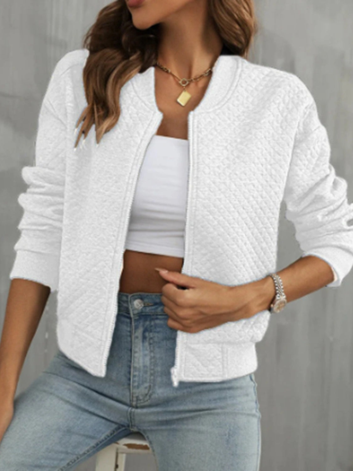 Front view of white quilted bomber jacket, a clean, versatile layering piece.
