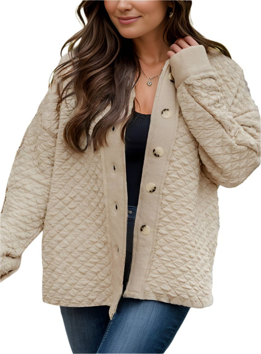 Woman wearing quilted oversized button-up jacket in oatmeal color.
