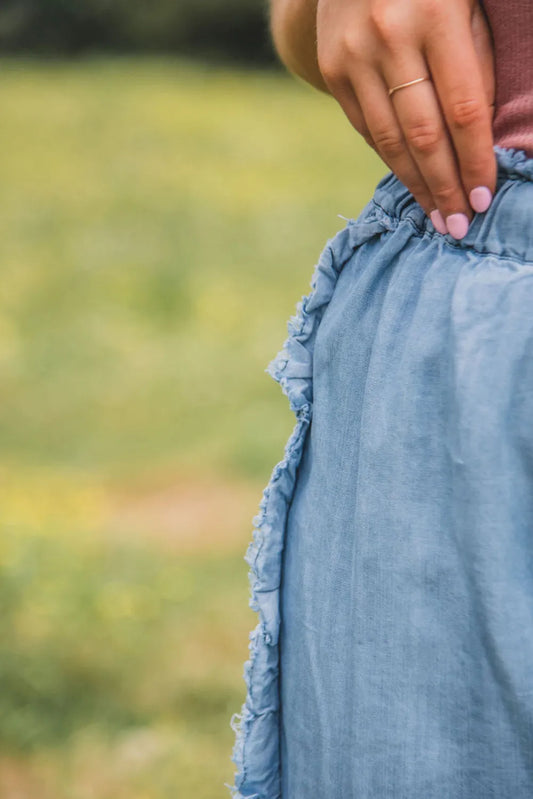 Waistband detail of raw hem wide-leg pants showcasing the adjustable drawstring feature.
