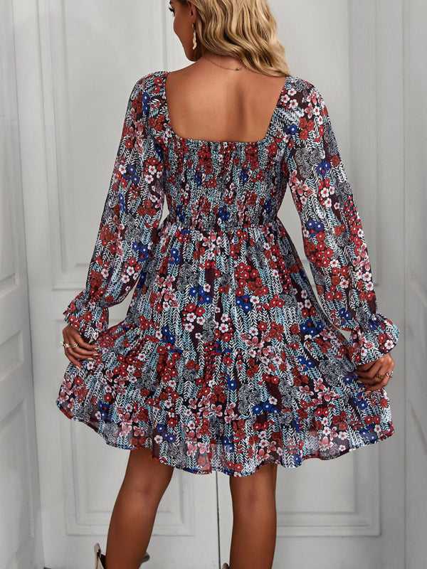 Red bohemian floral dress with a square neckline, long sleeves, and tiered ruffled hemline.
