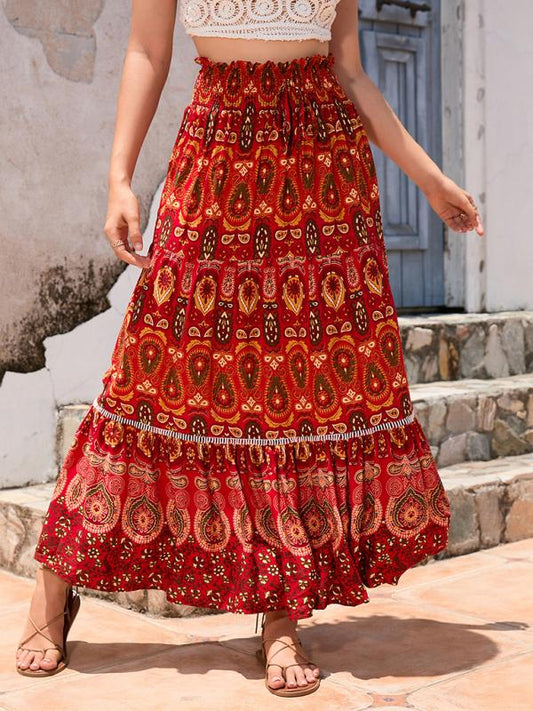 Front view of a red bohemian printed patchwork maxi skirt with bold patterns.
