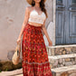 Full-length image of a lightweight red boho maxi skirt with an A-line design.






