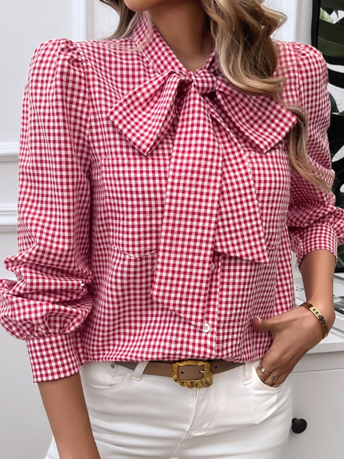 Red gingham bow tie blouse, perfect for pairing with white jeans for a classic look.
