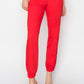 Women's red high-waisted jogger jeans with soft, slightly stretchy fabric for comfort.
