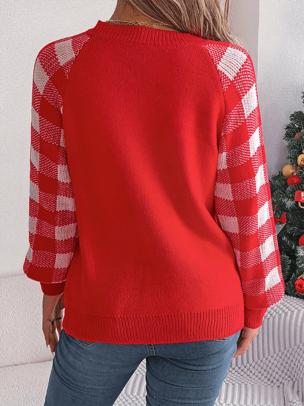 Cozy red holiday sweater with a reindeer graphic and plaid sleeves, perfect for Christmas festivities.