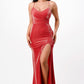 Model wearing a red mermaid gown with spaghetti straps and a side slit, front view.
