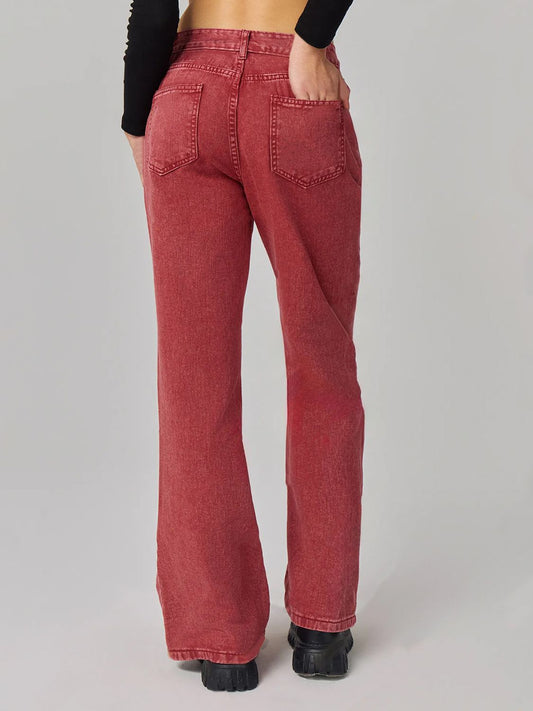 Back view of red vintage bootcut jeans highlighting clean pocket details and sleek design.
