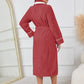 Belted red winter robe with contrast trim, ideal for cold mornings.
