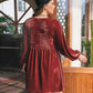 back view of reddish brown dress with lace hem
