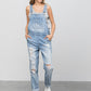 Full-length view of distressed patch pocket light wash overalls 
