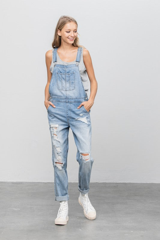 Full-length view of distressed patch pocket light wash overalls 
