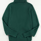 Cozy green turtleneck sweater with "Merry" embroidery, perfect for winter
