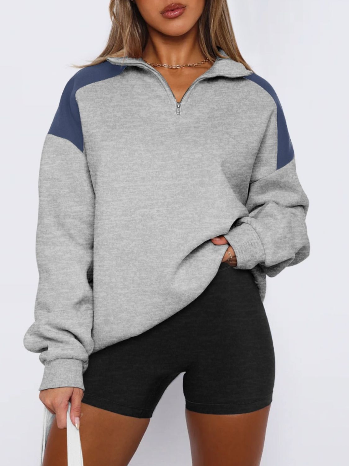 Gray color block half-zip sweatshirt for women, perfect for a relaxed look.
