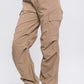 Side view of khaki loose-fit cargo pants styled for a casual day out.
