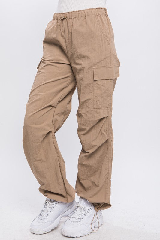 Side view of khaki loose-fit cargo pants styled for a casual day out.
