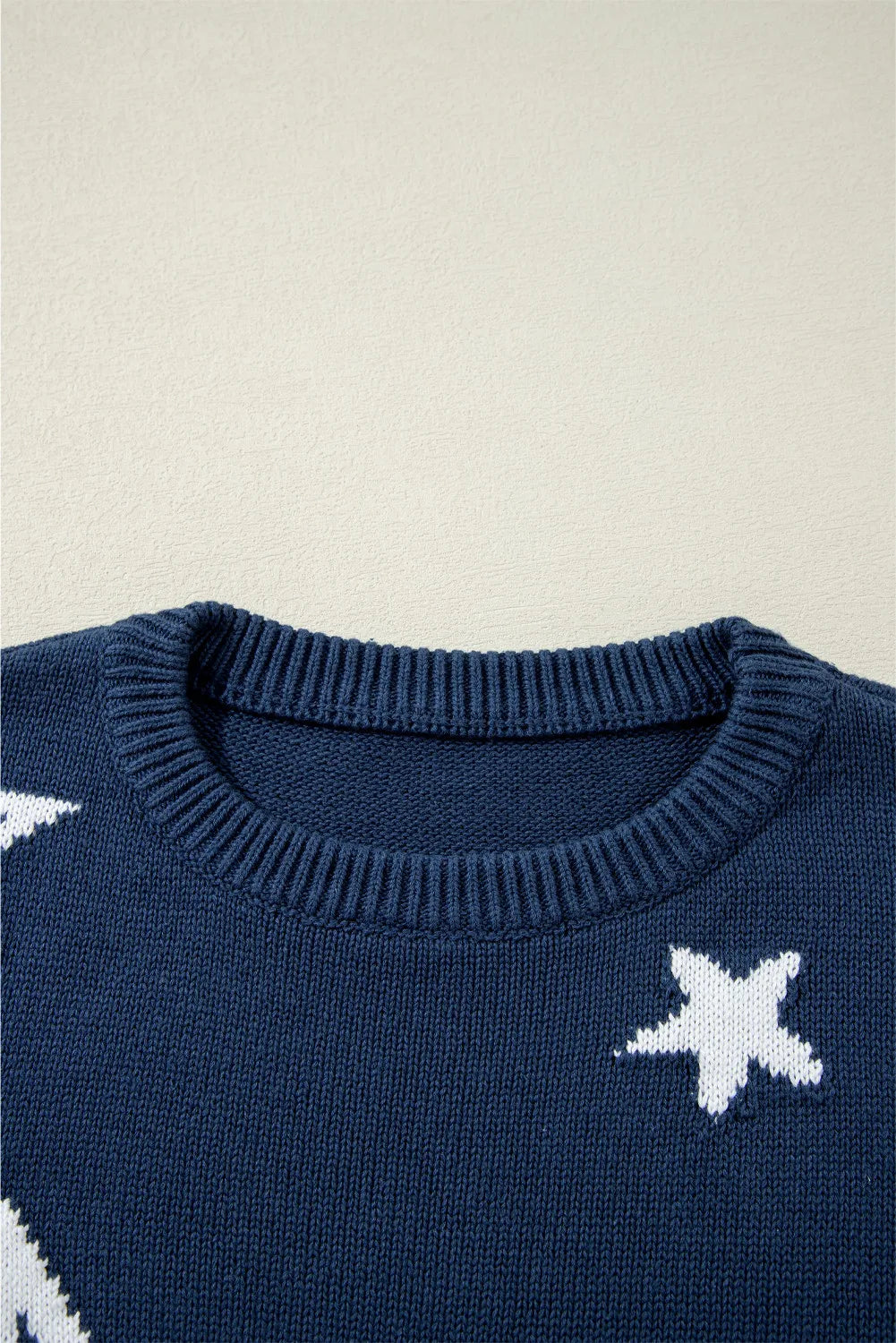 Relaxed fit navy sweater with white stars, made from 100% cotton for ultimate comfort.

