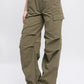 Side view of olive loose-fit cargo pants with functional pockets.
