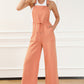 Women’s wide-leg drawstring overalls in soft peach fabric with functional pockets.
