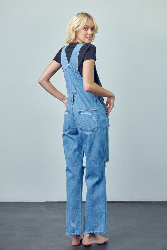 Full-length ripped denim overalls with a structured, relaxed silhouette.
