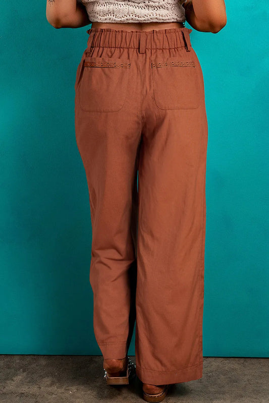 Back view of wide-leg drawstring pants with pocket detail and relaxed fit.
