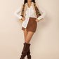 Bohemian faux shearling vest with intricate floral embroidery, women’s style.
