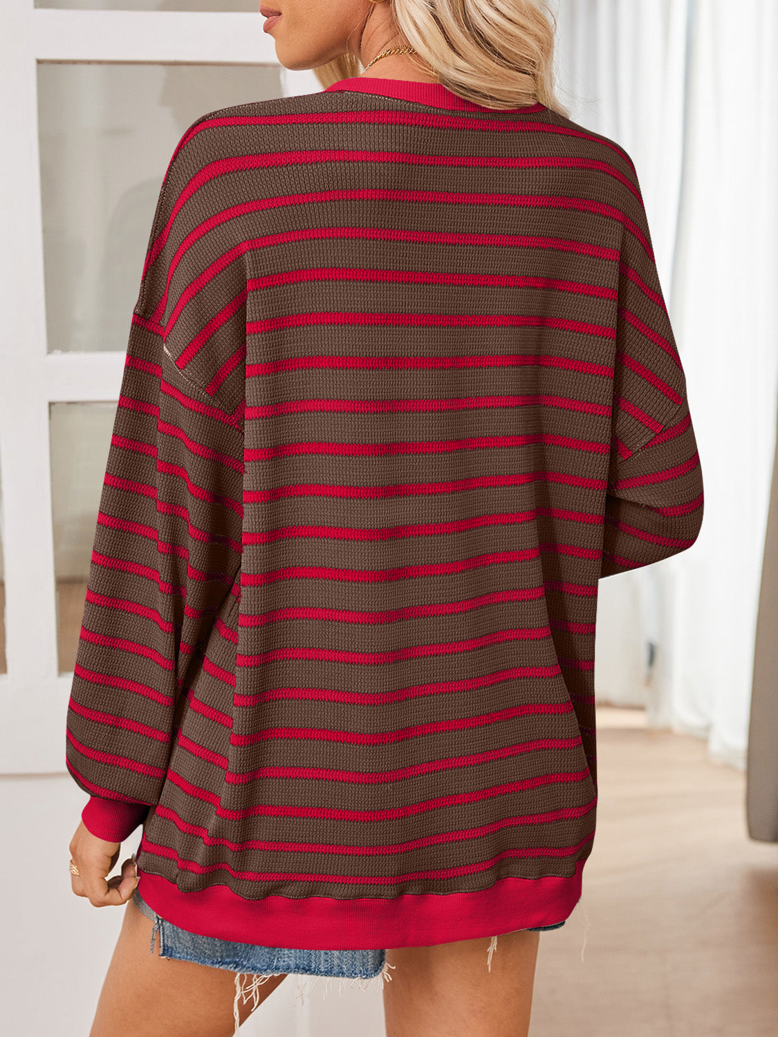 Brown and red striped oversized pullover styled casually with denim.