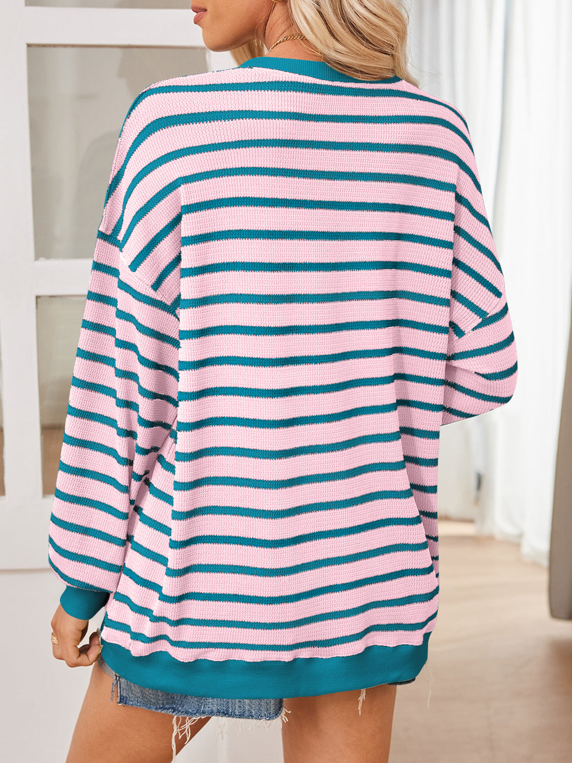 Soft and stretchy pink striped sweater with retro teal stripes.
