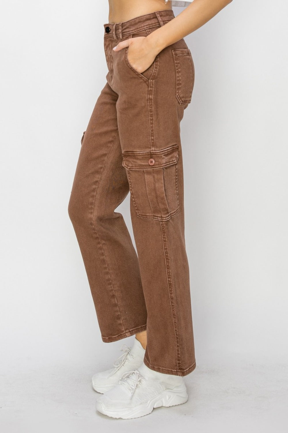 Side view of caramel-colored cargo jeans highlighting the high-rise fit.
