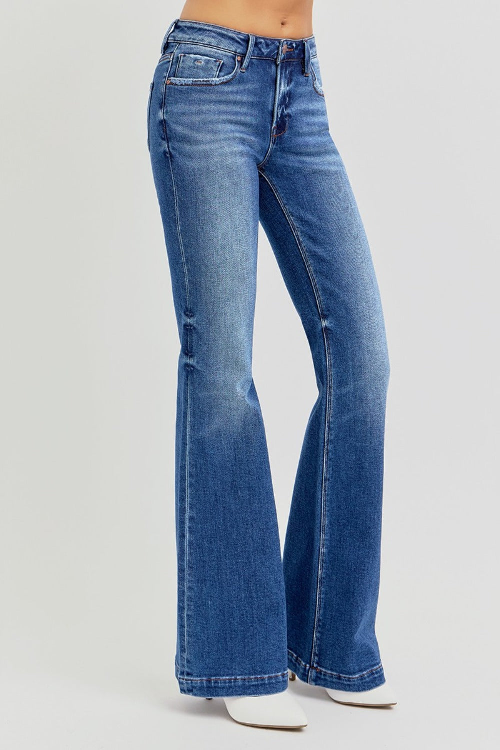 Medium wash RISEN low rise flare jeans highlighting the timeless flare silhouette.
