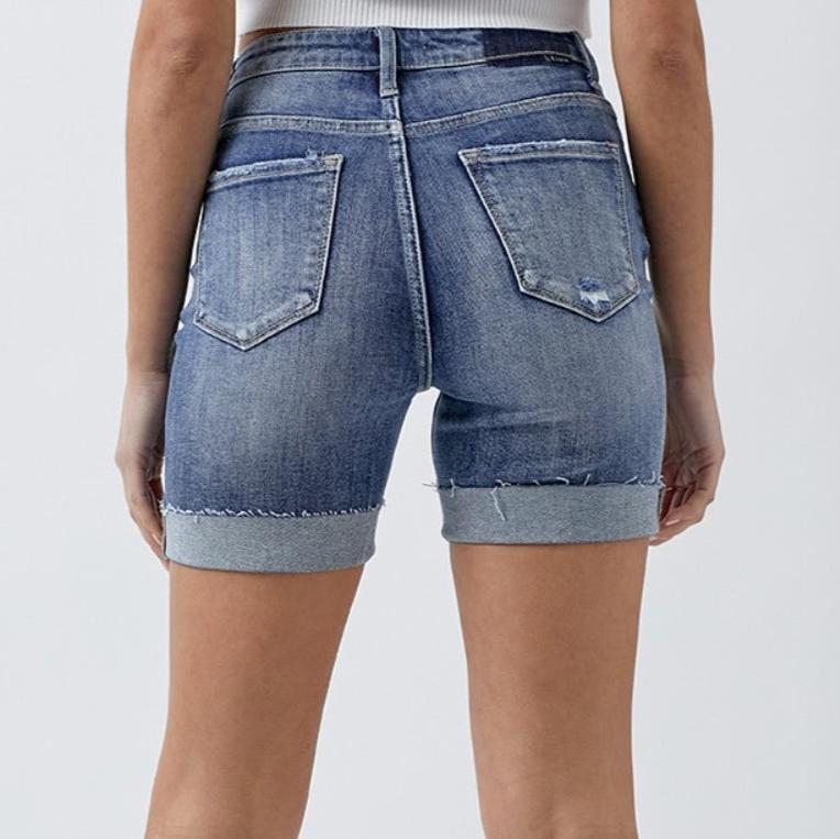 Back view of RISEN distressed rolled denim shorts with pockets.