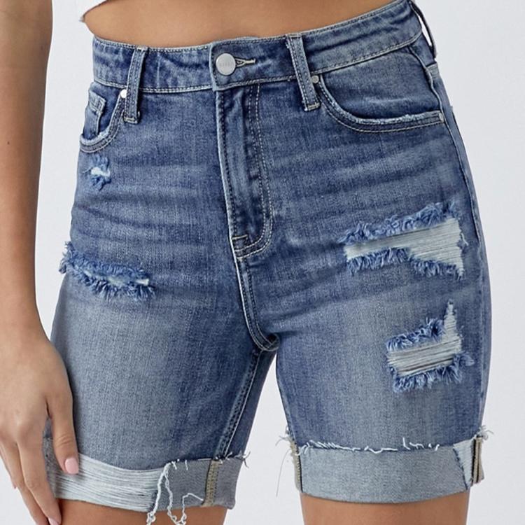 Front view of RISEN distressed rolled denim shorts with pockets.