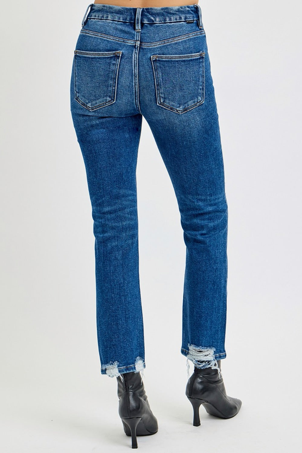 Back view of RISEN High Rise Distressed Crop Straight Jeans with raw hem and pocket detail.
