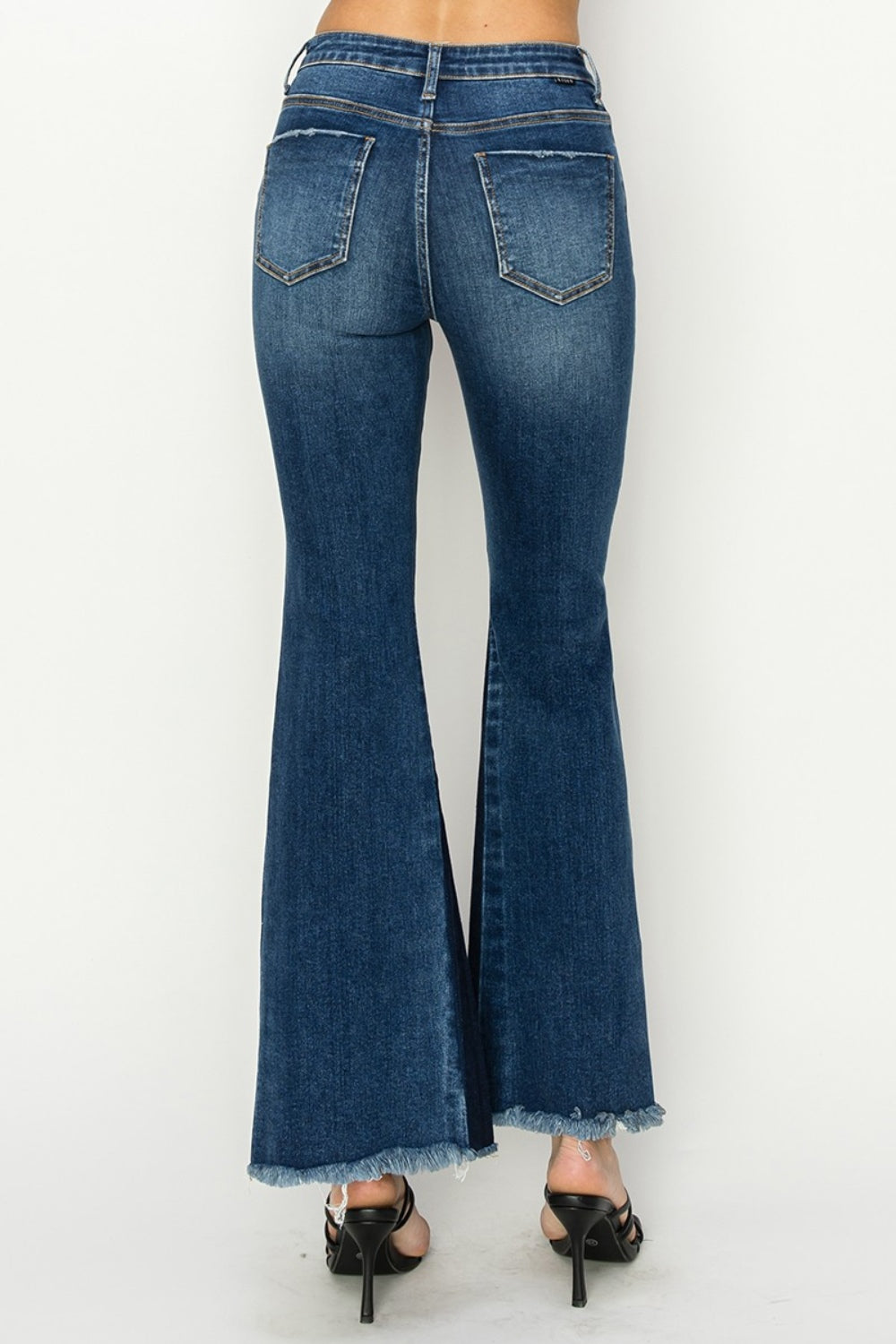 Back view of RISEN High Rise Side Shadow Seam Detail Slit Flare Jeans, focusing on the fit and pocket design.