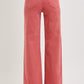 Back view of RISEN High Rise Tummy Control Wide Leg Jeans in a bold brick color with pocket details.
