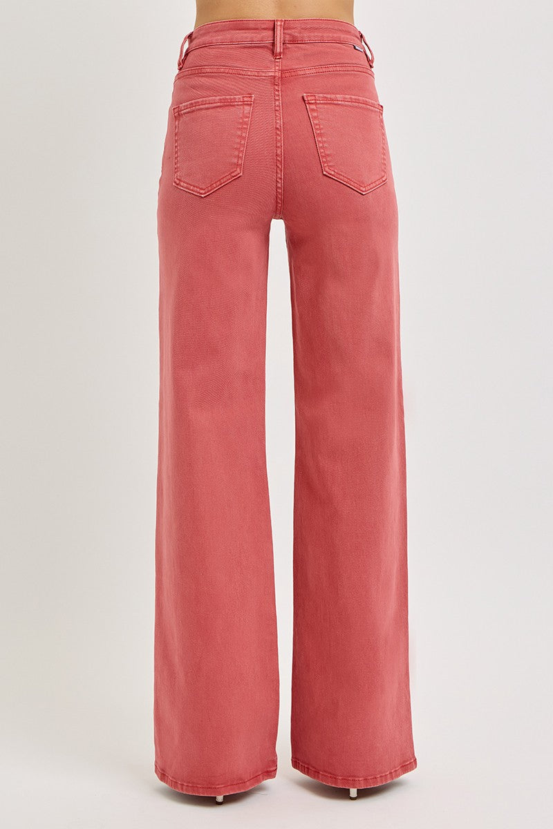 Back view of RISEN High Rise Tummy Control Wide Leg Jeans in a bold brick color with pocket details.
