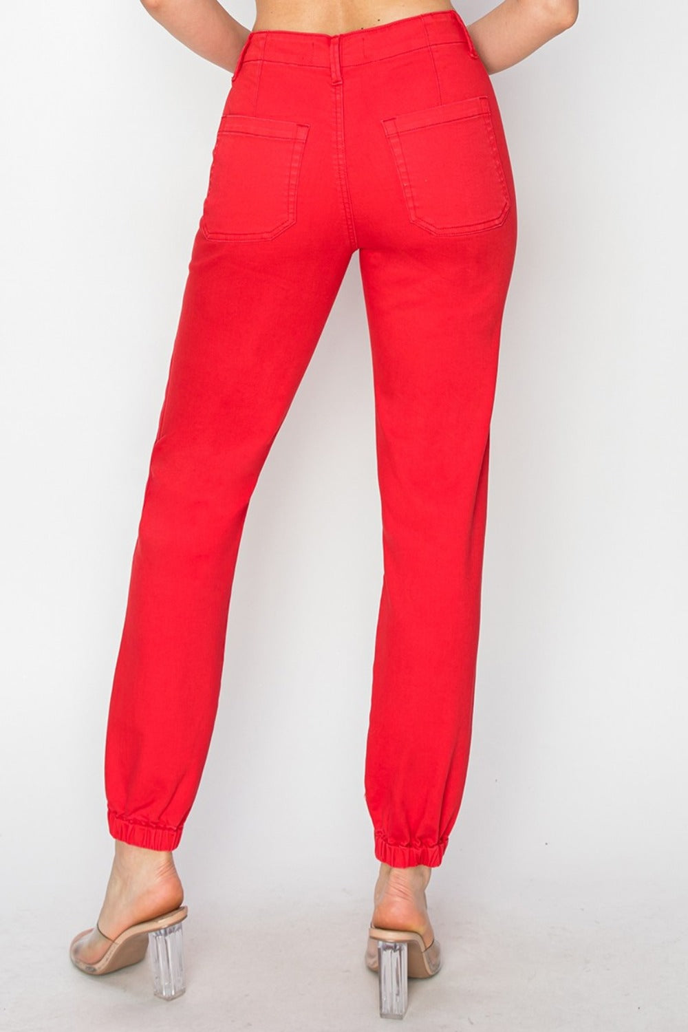 Back view of RISEN High Waisted Jogger Jeans with a flattering fit and stylish red color.
