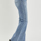 Vintage-inspired flare jeans in medium wash with raw hem detail
