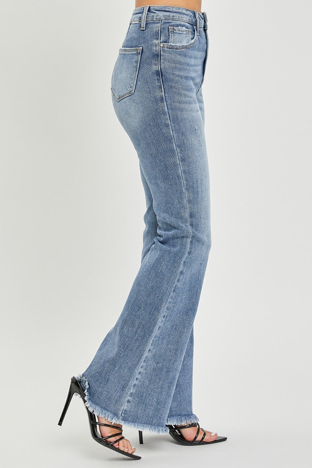 Vintage-inspired flare jeans in medium wash with raw hem detail
