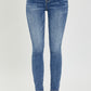 RISEN Mid Rise Ankle Skinny Jeans in a mid-wash, offering a versatile option for any occasion.