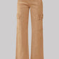 RISEN wide-leg cargo jeans in camel paired with black heels for a trendy look.
