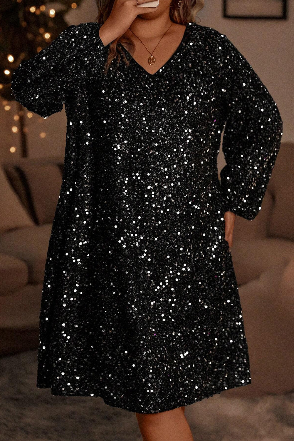 Plus-size black sequin dress styled for a party-ready look
