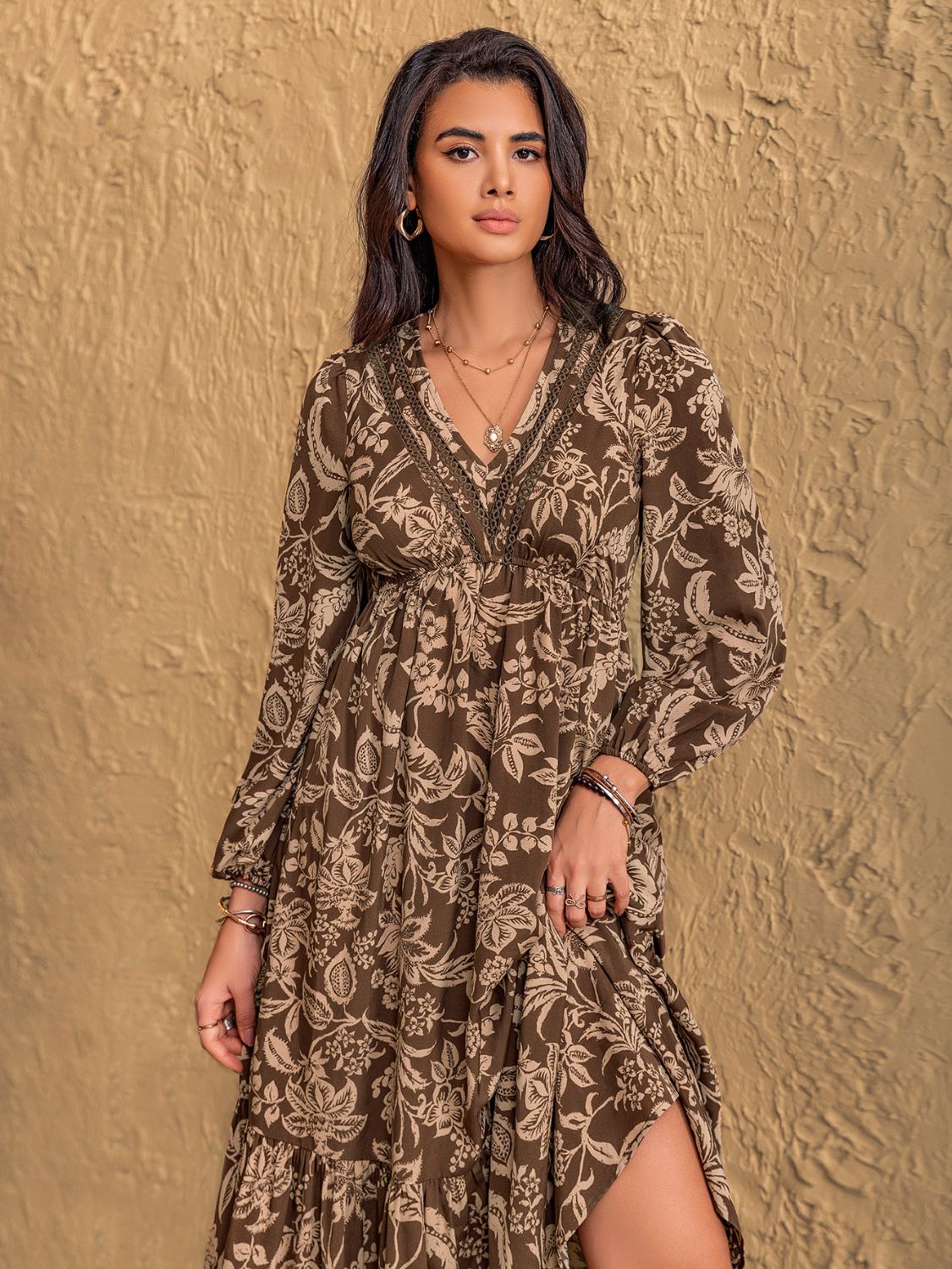 Flowy and relaxed printed long sleeve dress with tiered skirt.
