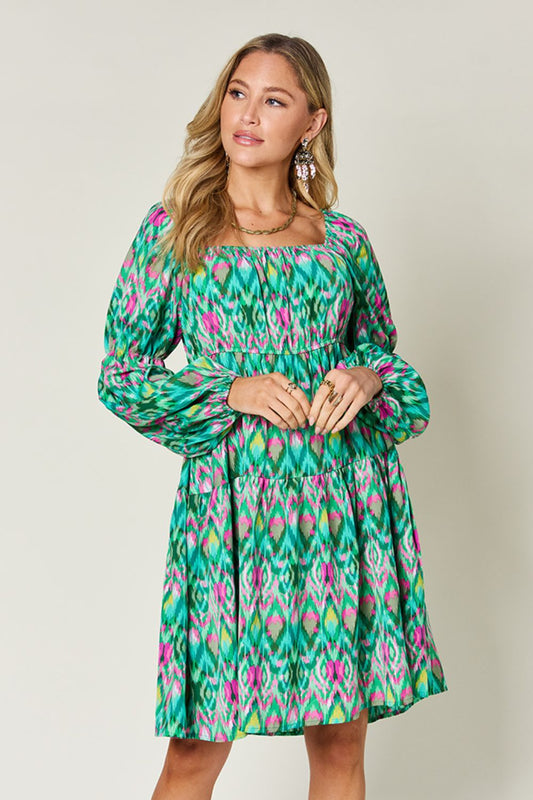 Green ikat dress with a flattering square neckline and ruched bodice.
